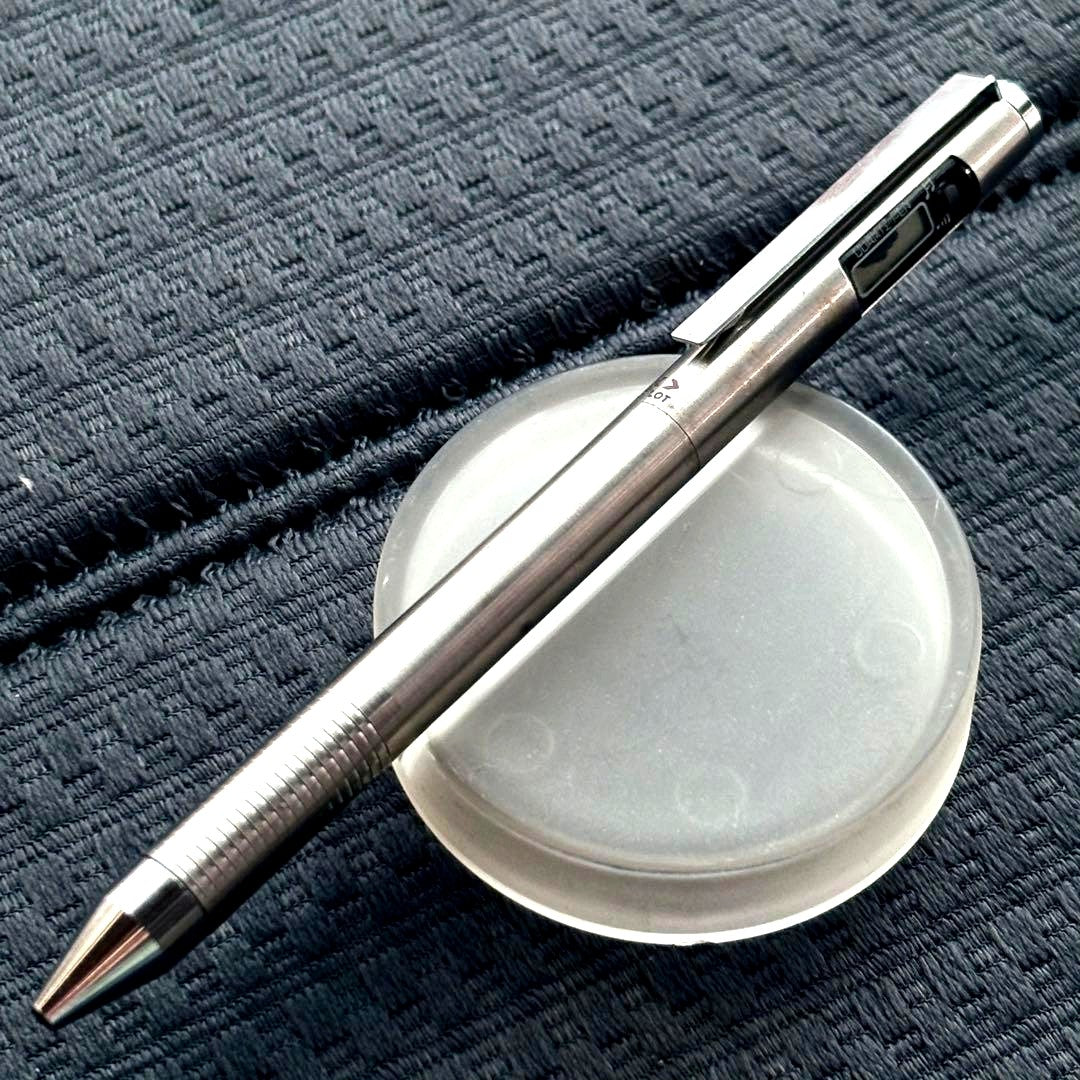 Pilot Quartz Pen in two colors with multi-function features and an included watch showing signs of wear