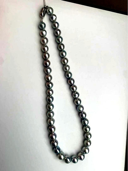 Akoya pearl necklace with natural blue pearls sized 9 to 10 millimeters arranged on a white background