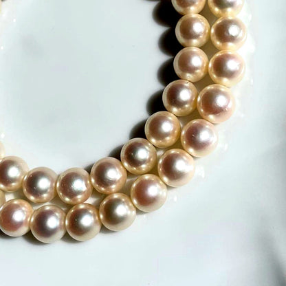Akoya pearl necklace with 7.5-8mm white pearls and silver clasp displayed on a white background