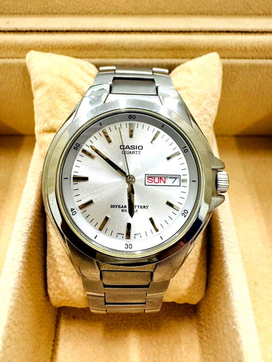 Casio men's silver quartz watch with stainless steel band showing date and day display