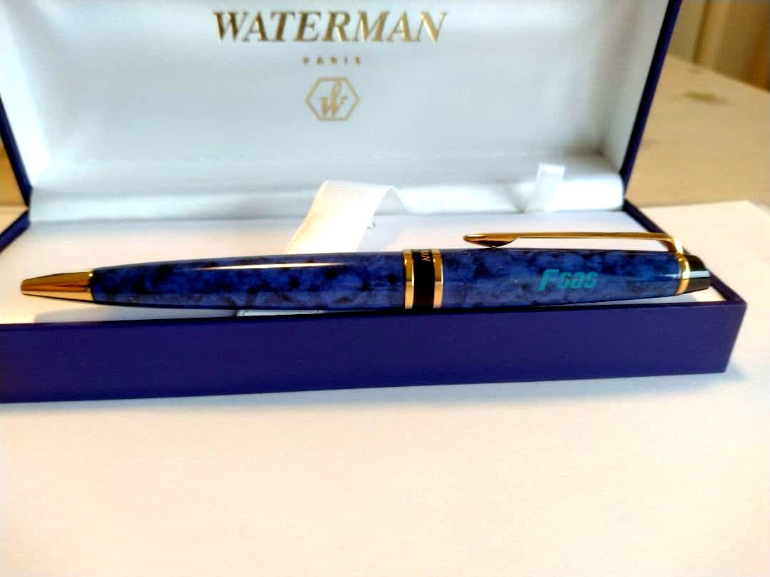 Waterman ballpoint pen in blue marble pattern with gold trim and twist mechanism, displayed with dedicated case