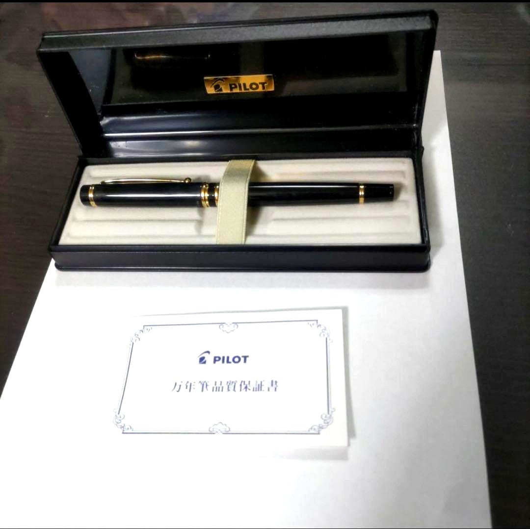 New Pilot Graice fountain pen in black and gold with 14k gold nib shown uncapped and writing