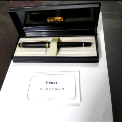 New Pilot Graice fountain pen in black and gold with 14k gold nib shown uncapped and writing