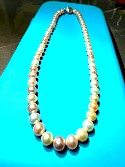 Close-up of a single lustrous Akoya pearl on a white background