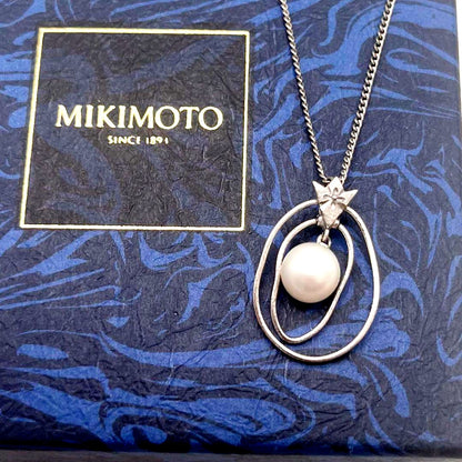Mikimoto necklace with one cultured white pearl bead on a silver chain with Mikimoto engraved clasp