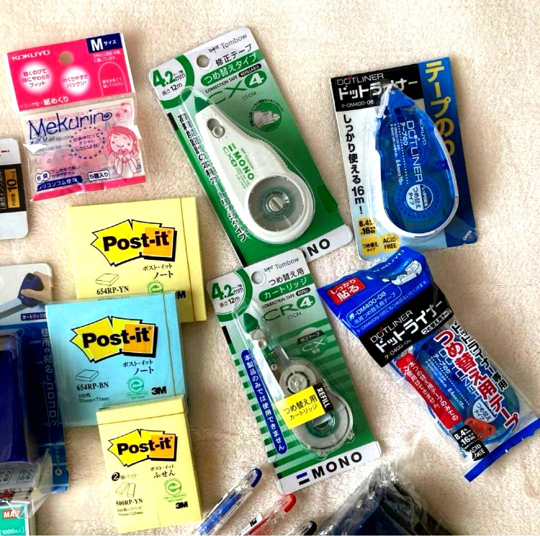 Unspecified Brand stationery assortment with ink pad, stapler, Post-it notes, correction tape, pen, glue stick, and hole punch