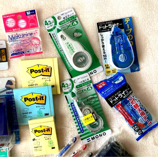 Unspecified Brand stationery assortment with ink pad, stapler, Post-it notes, correction tape, pen, glue stick, and hole punch