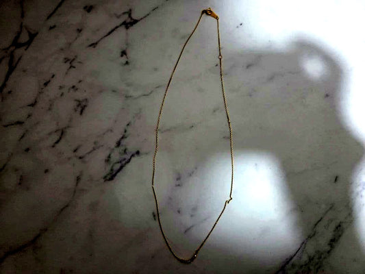 Agete K18 gold necklace featuring a 0.04 carat diamond with a stylish curve motif design