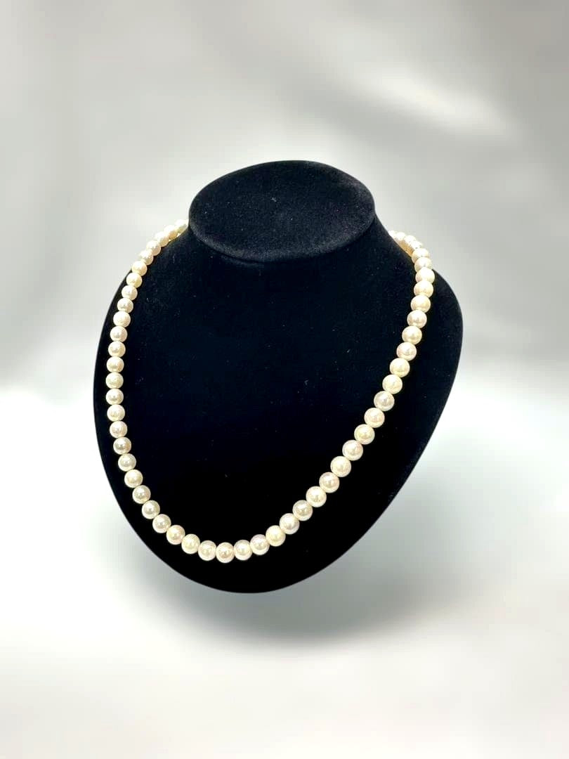 Akoya pearl necklace with 6.0mm pearls and silver clasp, displayed with stamped case