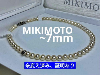 MIKIMOTO K14 Akoya pearl necklace with 6.5-7mm pearls, M charm, and K14WG mark on white background