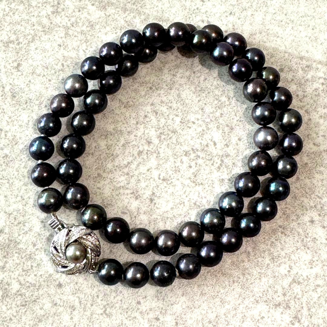Honma Pearl genuine black Akoya pearl necklace with 7.4mm pearls and silver clasp on a white background
