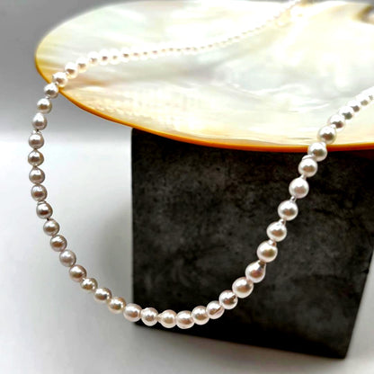 Akoya pearl baby pearl baroque necklace with white pink pearls and 925 clasp on white background