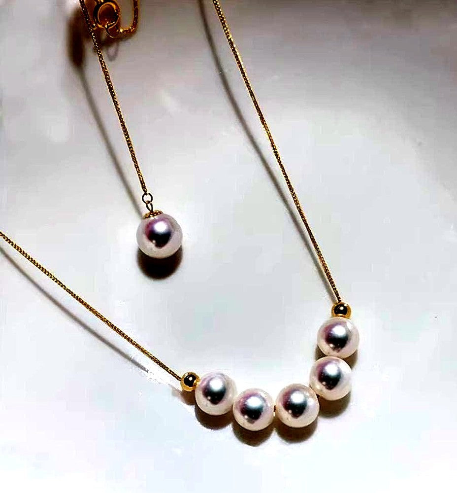 K18YG yellow gold necklace with 6-7mm Akoya pearls and Y-shaped 2Way Chopin chain on white background