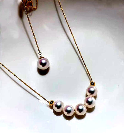K18YG yellow gold necklace with 6-7mm Akoya pearls and Y-shaped 2Way Chopin chain on white background