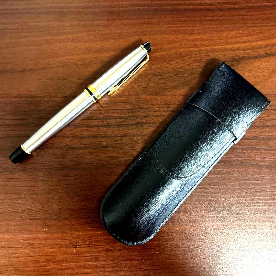 Vintage Waterman fountain pen with case showing minor scratches and dirt on the pen body