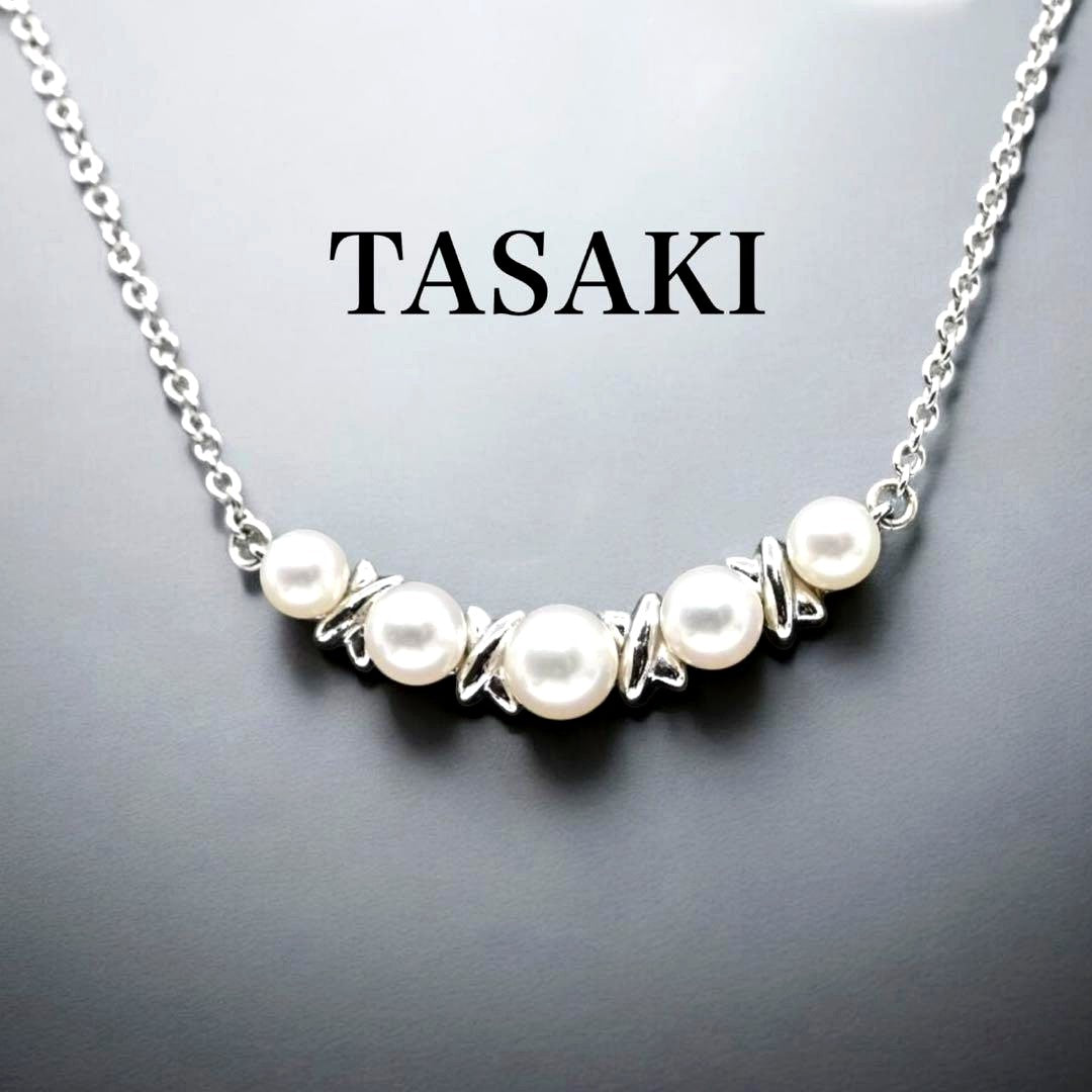 Tasaki Akoya pearl necklace pendant with round genuine pearls and silver clasp on a white background