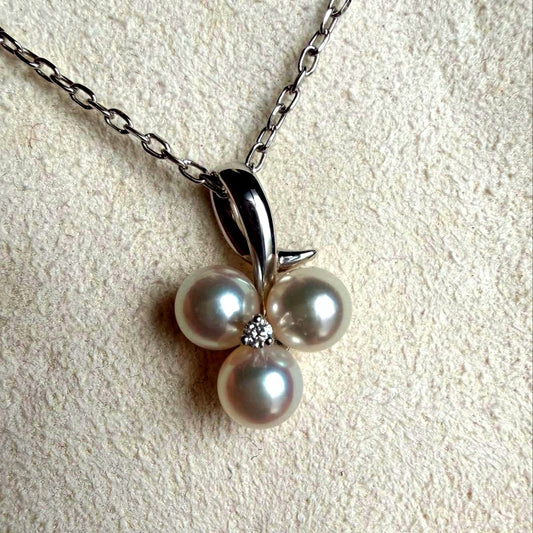 Mikimoto Akoya pearl and diamond necklace with three-strand design and floral motif on silver-colored metal chain