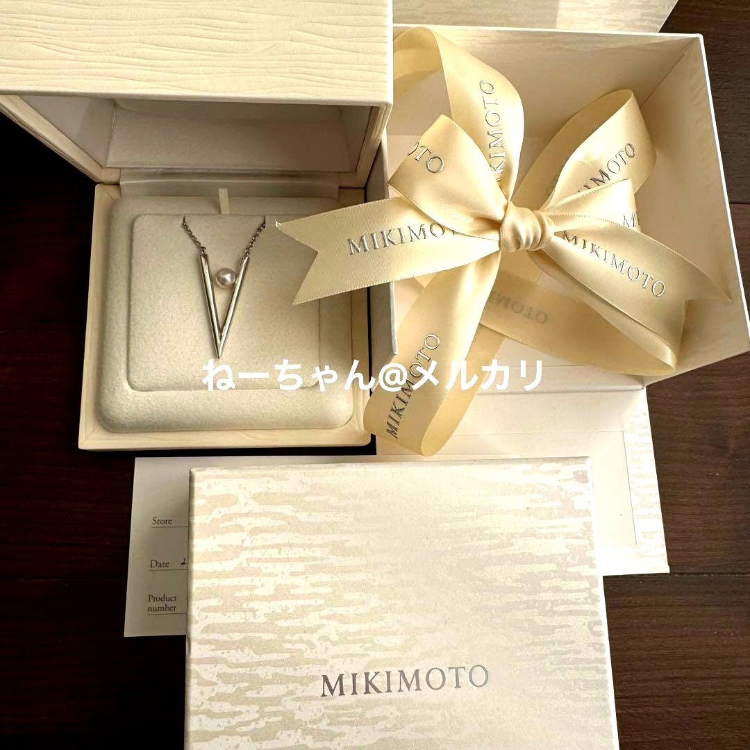 MIKIMOTO V Code silver pendant displayed with box, ribbon, and shop card