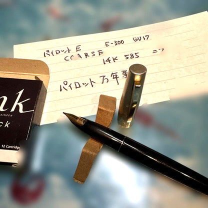 Pilot E-300 GU17 limited edition fountain pen with 14K gold coarse nib and black barrel shown writing characters