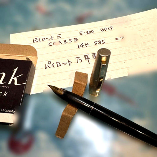 Pilot E-300 GU17 limited edition fountain pen with 14K gold coarse nib and black barrel shown writing characters