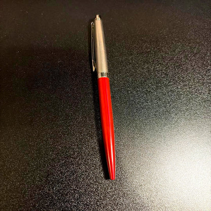 Blue ballpoint pen with smooth ink tip and ergonomic grip on white background