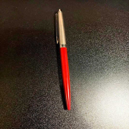 Blue ballpoint pen with smooth ink tip and ergonomic grip on white background