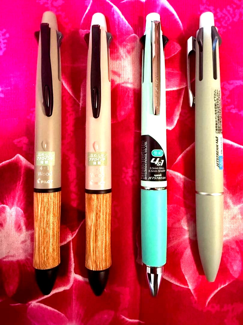 Set of four multi-color ballpoint pens, some featuring mechanical pencil function