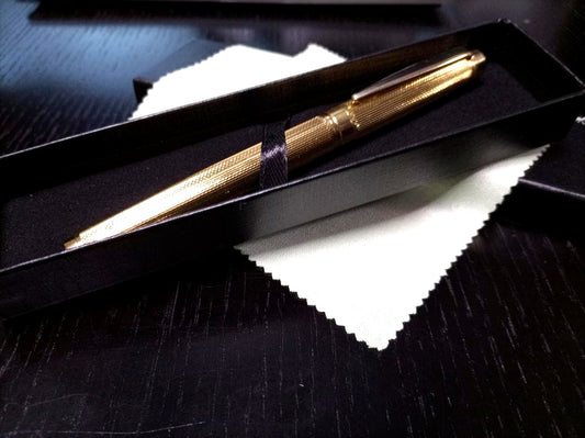 Champagne gold ballpoint pen with rounded body and black gel refill displayed on white background