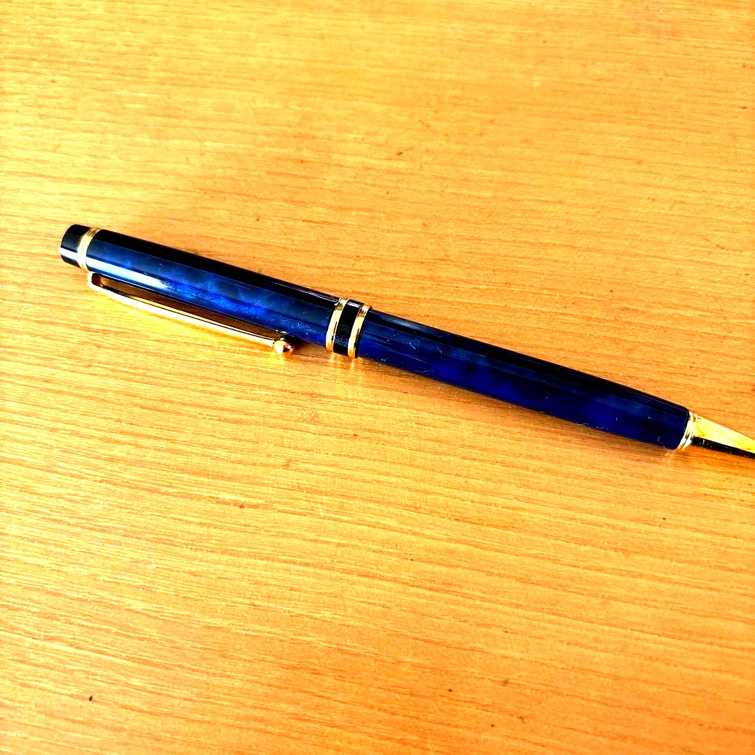 Pilot ballpoint pen with blue body, gold decorative accents, two-tone design, and rotating mechanism