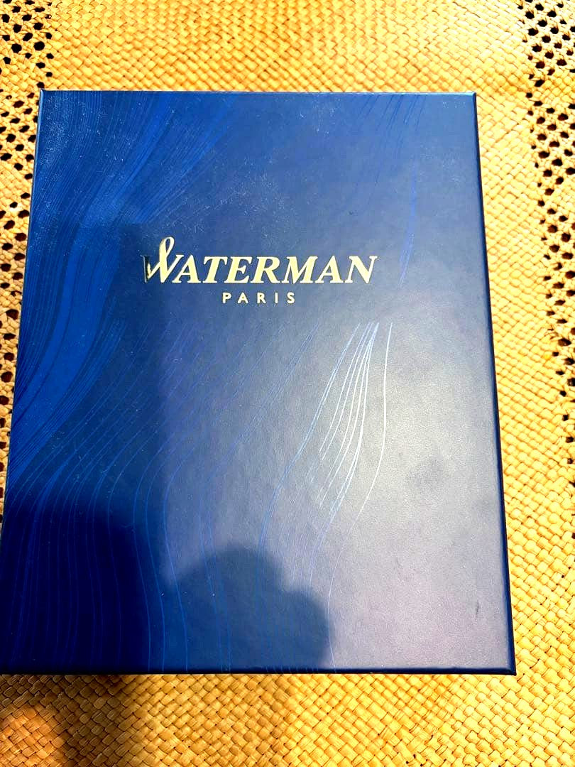Waterman ballpoint pen in black and gold with matching pen case set on white background