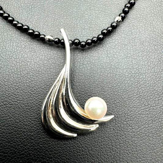 Mikimoto M Mark genuine pearl pendant with thin black coral silver bead necklace on white background
