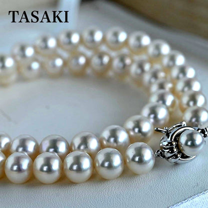 Hanadama Akoya pearl necklace with round 8-8.5mm pearls and silver fastener on a white background