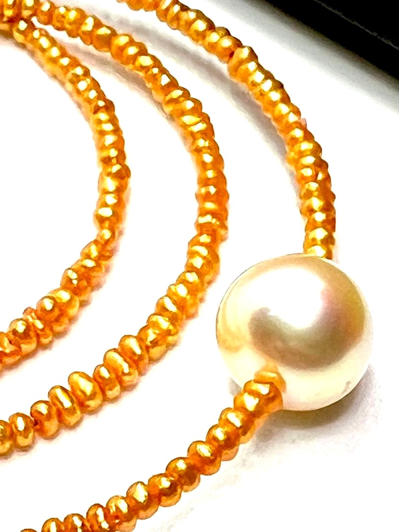 Gold Akoya pearl necklace featuring 8.5mm gold pearls and 2mm gold Kesh baby pearls on adjustable chain