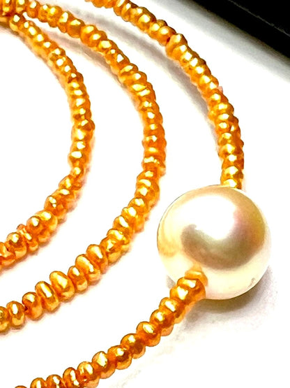 Gold Akoya pearl necklace featuring 8.5mm gold pearls and 2mm gold Kesh baby pearls on adjustable chain