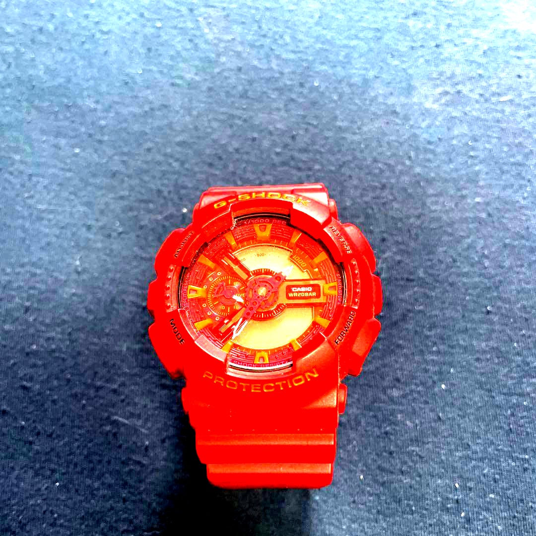 Casio G-Shock red watch with shock resistance, water resistance, red resin case, and stainless steel buckle