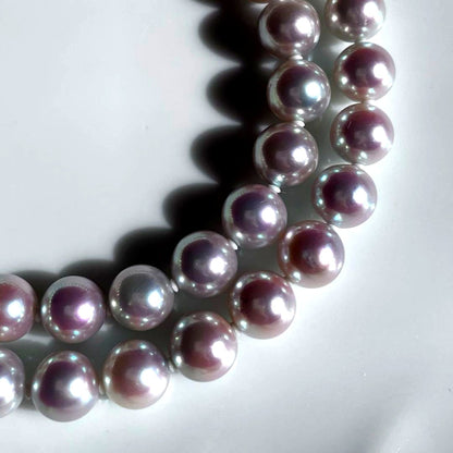 Akoya pearl necklace with 7.5-8mm blue tone pearls and silver clasp displayed with certification and box
