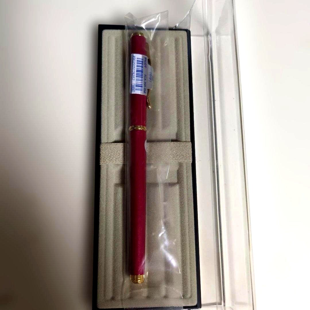 Red metal Pilot FCA-53R-RM fountain pen with included case on white background