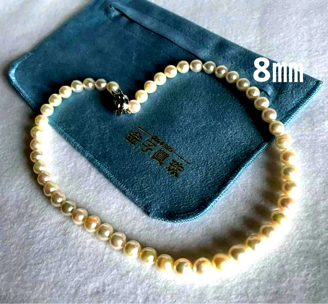 Natural 8mm Akoya pearl necklace with baroque pearls and silver clasp on a white background