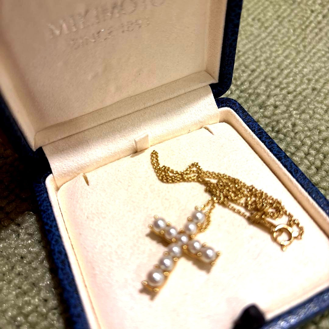 Kuro Cross Cross Shape necklace in K18YG yellow gold with pearl accents on a white background