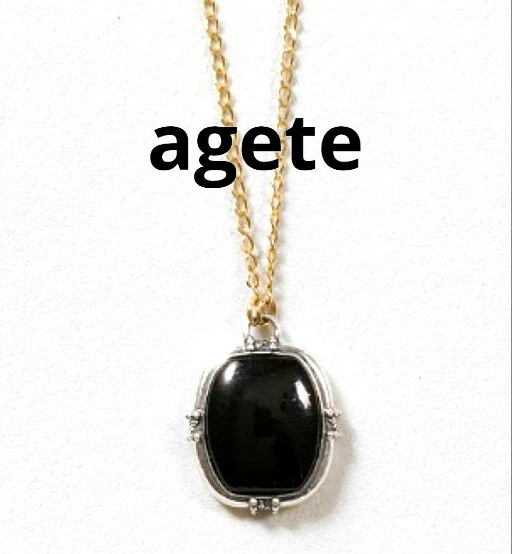 Agete K10 gold and silver necklace with small pendant and adjustable chain laid flat