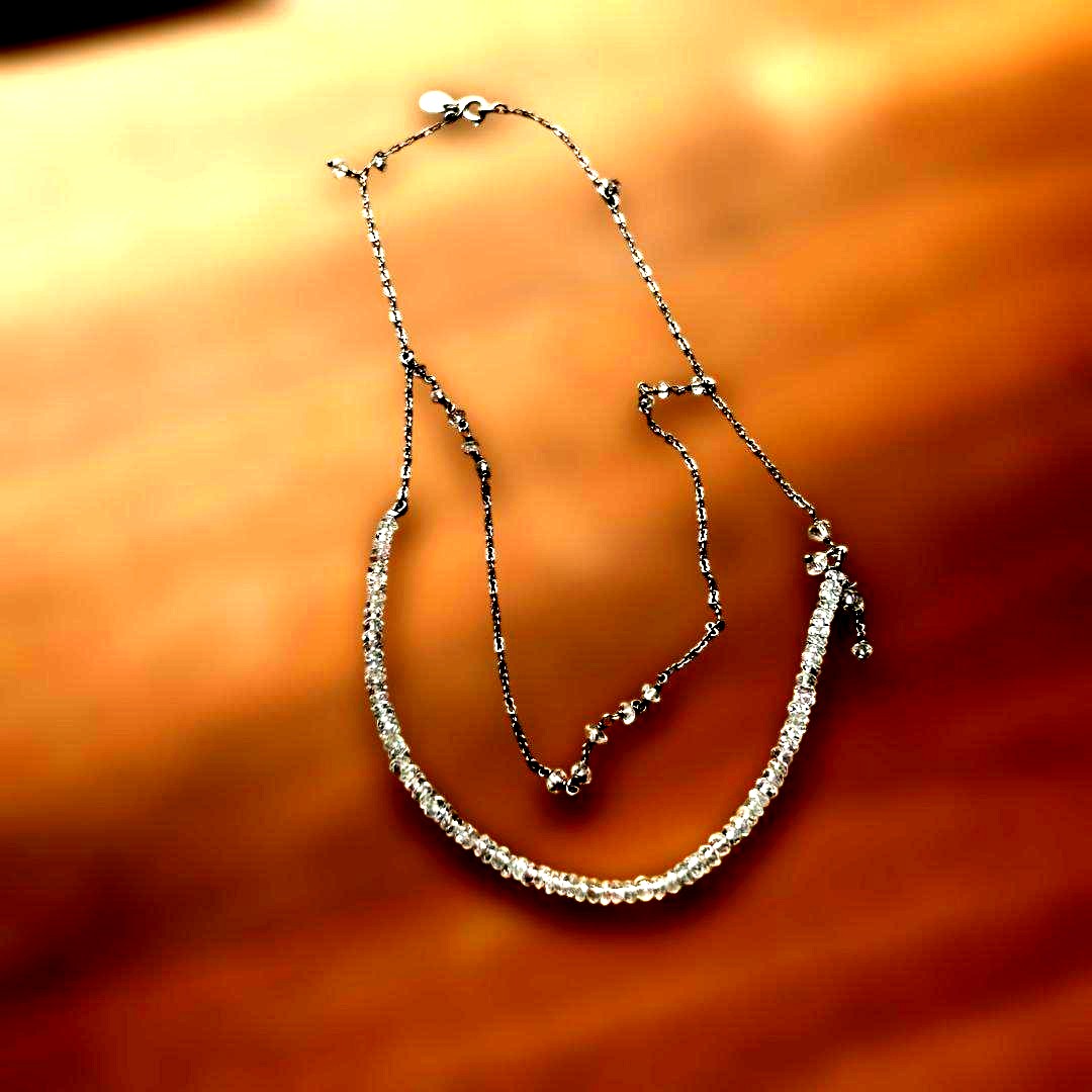 Agete Kuro necklace featuring white beads and metal double chain with slight scratches and discoloration