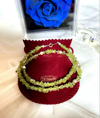 Pink Aurora Akoya Pearl necklace featuring 7 baby pearls and peridot stones with silver clasp