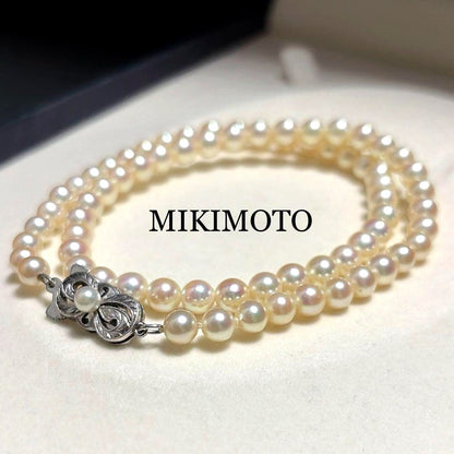 Mikimoto Akoya Pearl Necklace with 5.5mm baby pearls and high luster on a white background