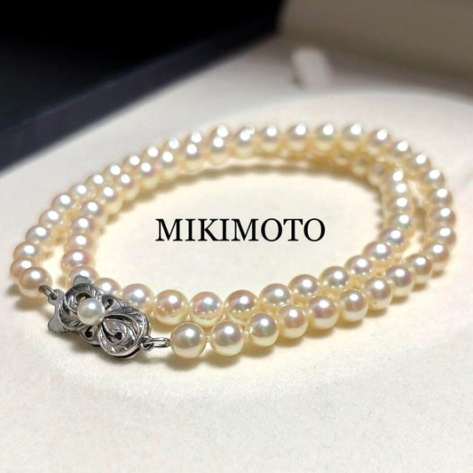 Mikimoto Akoya Pearl Necklace with 5.5mm baby pearls and high luster on a white background