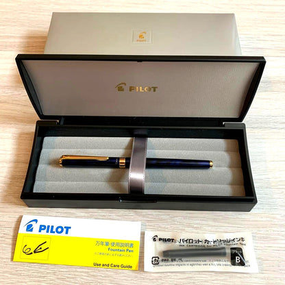 Pilot Cavalier Fountain Pen in dark blue with silver trim shown uncapped on white background