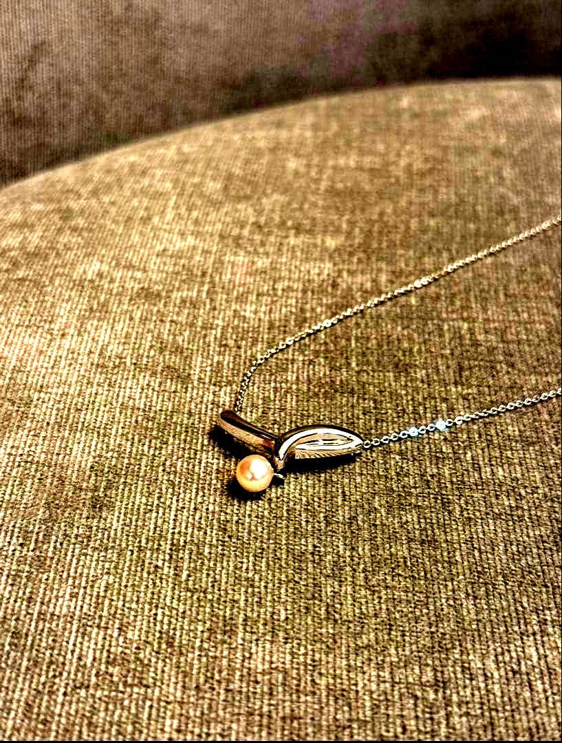 Tasaki silver necklace with a thin chain featuring a soft pearl and simple sophisticated design