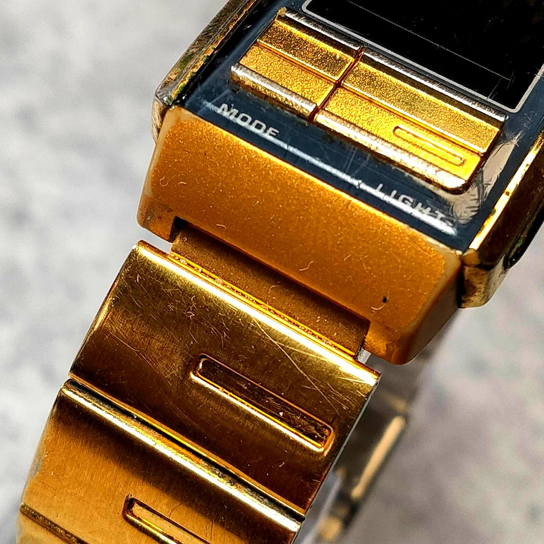 Casio Illuminator LA-201W gold watch with reversed LCD display showing time and date