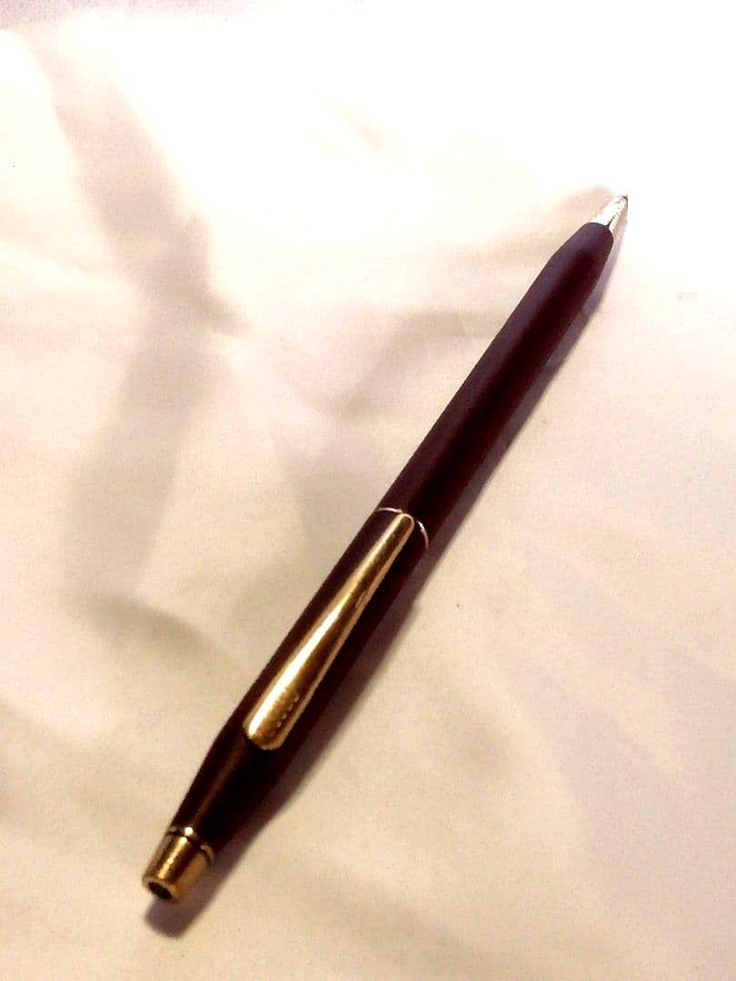 CROSS slim ballpoint pen in chic wine red color writing on paper