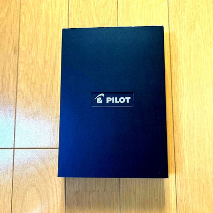 PILOT Z-GR-SBN black ballpoint pen alongside its black pen case with a damaged box