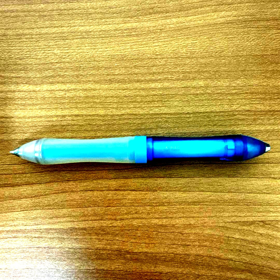 Discontinued PILOT Symmetry 0.5 pen with faded grip and partially worn logo shown in close-up